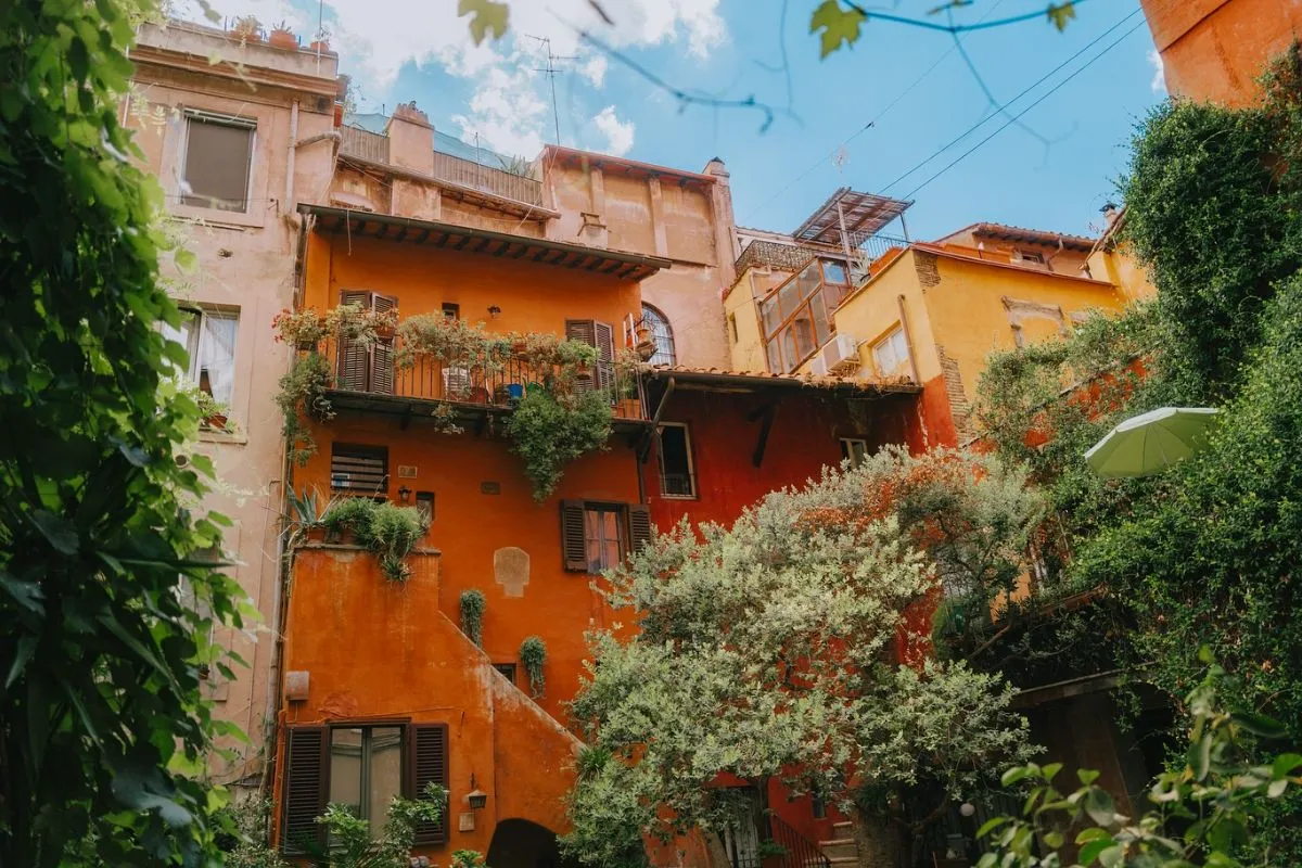 Hidden medieval courtyard Arco degli Acetari in Rome with ivy-covered ochre walls