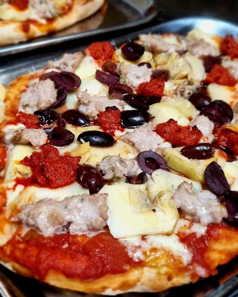 Freshly baked gluten free pizza in a Roman oven