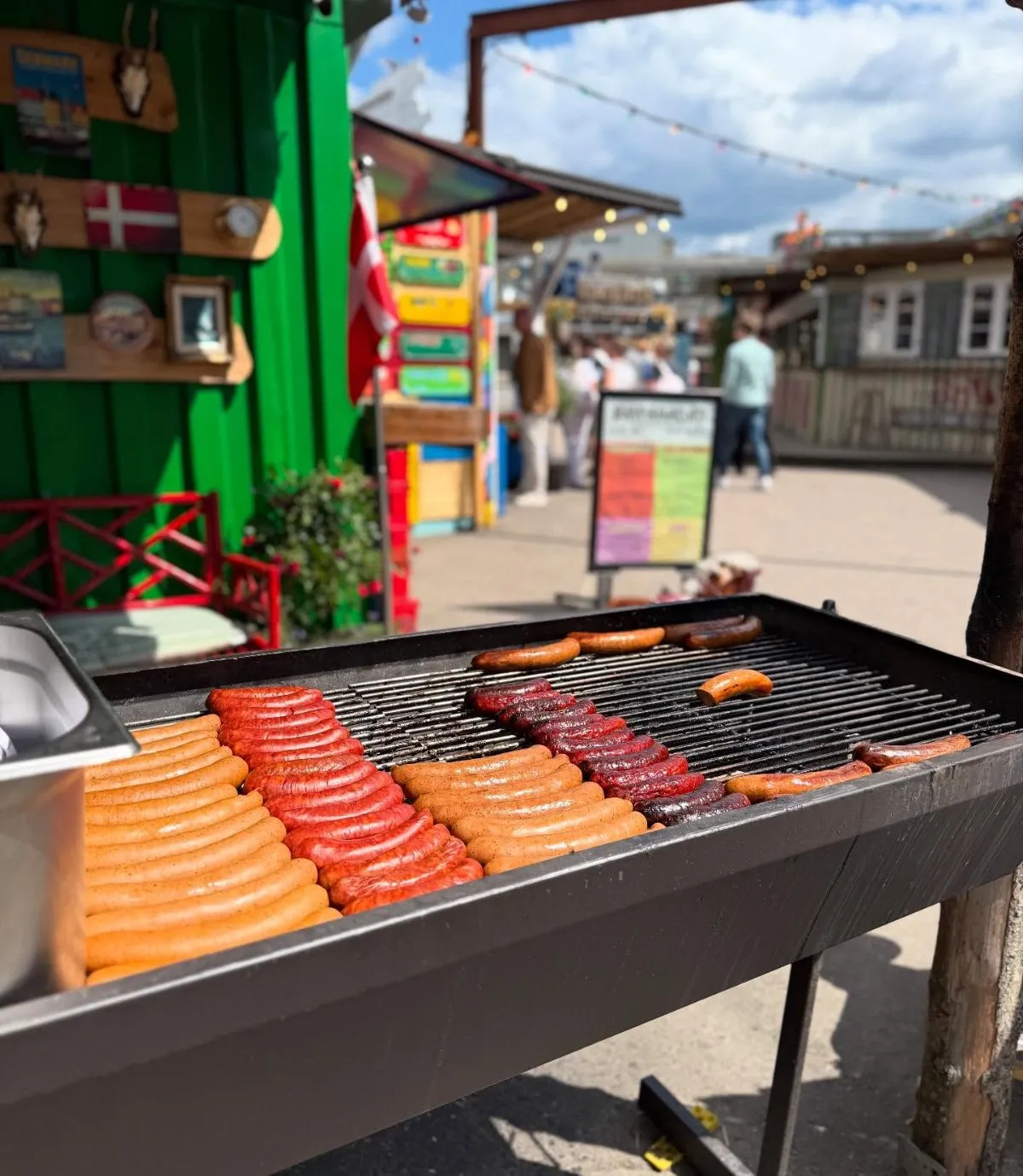 A cozy Copenhagen street scene featuring organic hot dogs and hearty stew on a wooden table, representing cheap food options for students.