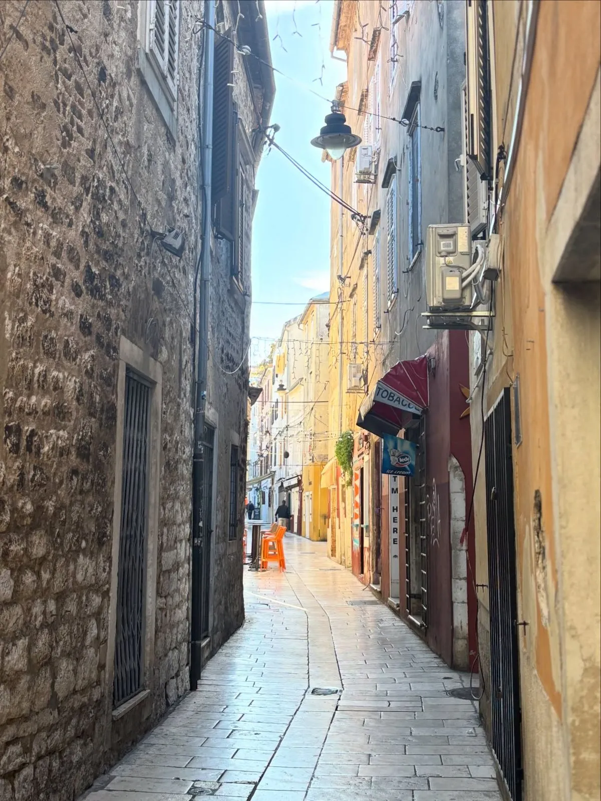 Narrow cobblestone street with Sobe signs in Croatia