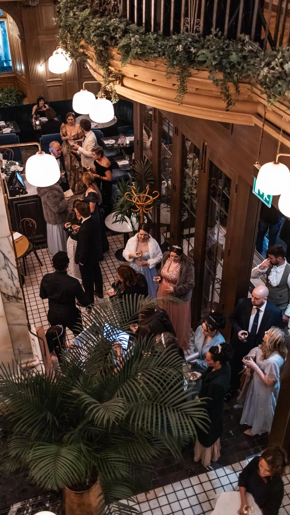A smartphone displaying a restaurant reservation app with the Edinburgh skyline in the background, illustrating pre-booking meals for Hogmanay.