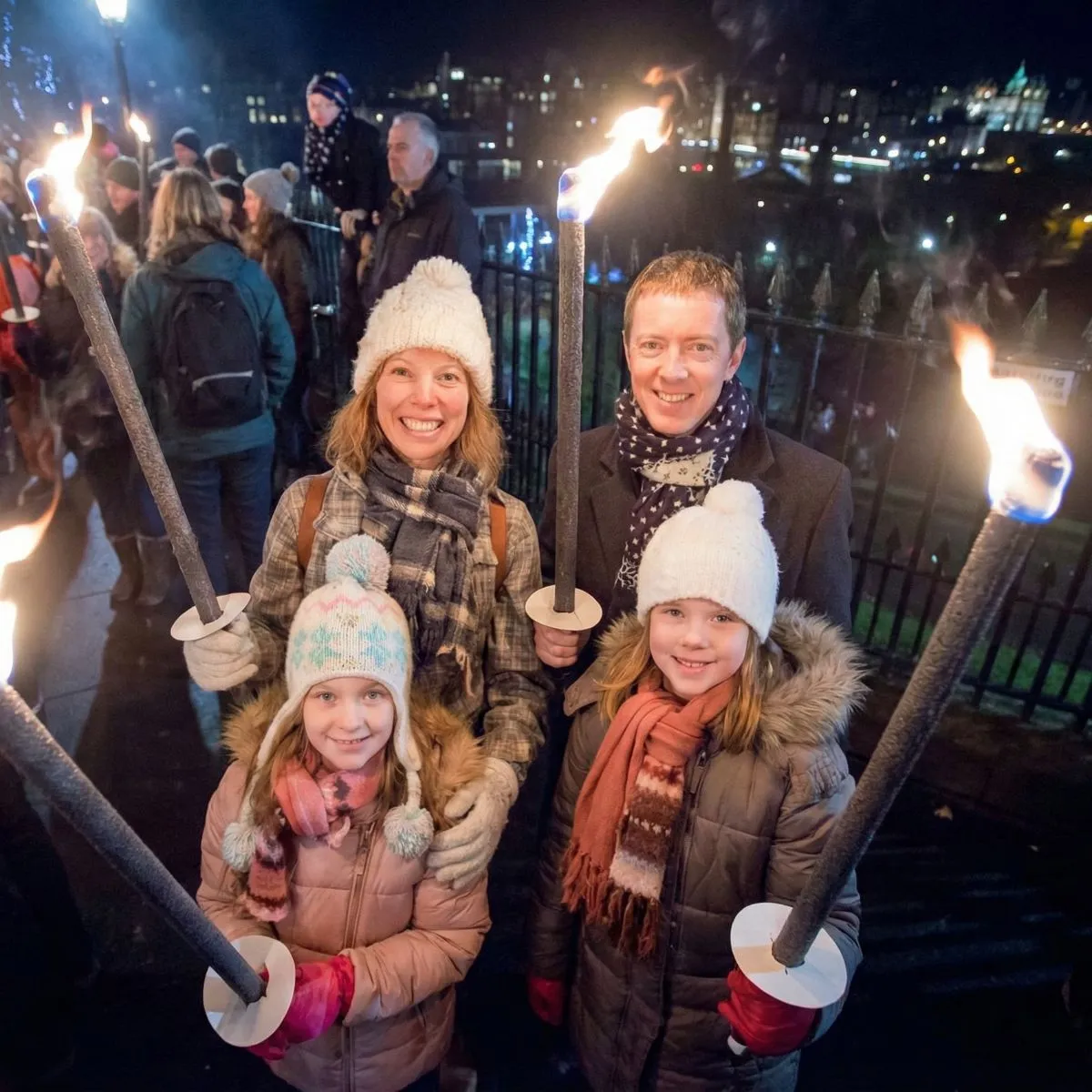 A family wearing colorful winter jackets, hats, and scarves stands on the Royal Mile in Edinburgh with the historic castle visible through winter mist.
