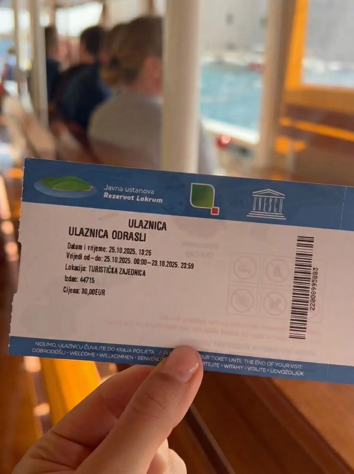 A local ferry ticket kiosk at a sunny Croatian port.