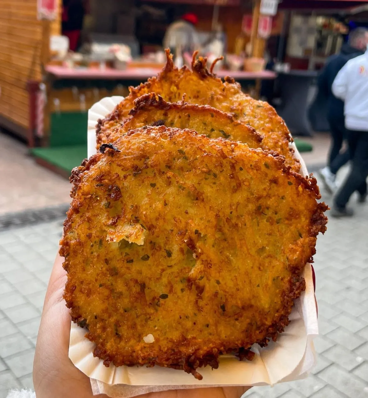 Freshly fried Gromperekichelcher potato pancakes at a market stall