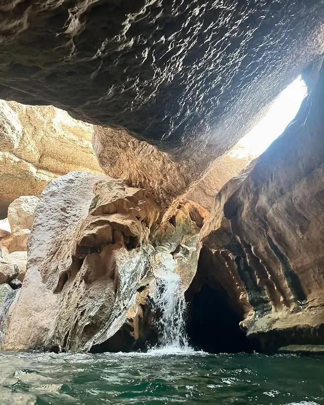 Hidden waterfall inside a limestone cave at Wadi Shab Oman