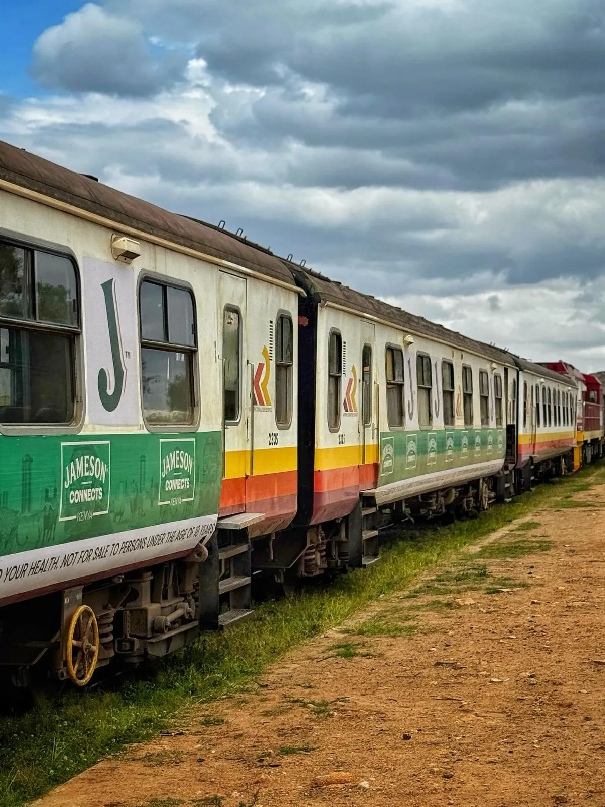Madaraka Express train traveling through the grassy plains of Tsavo National Park