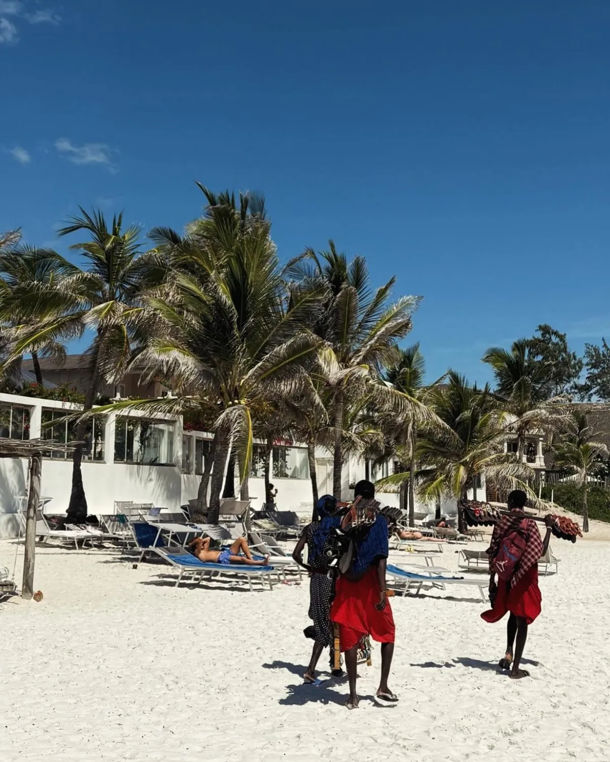 Split view of turquoise Mombasa ocean waters transitioning into red earth Tsavo National Park savanna