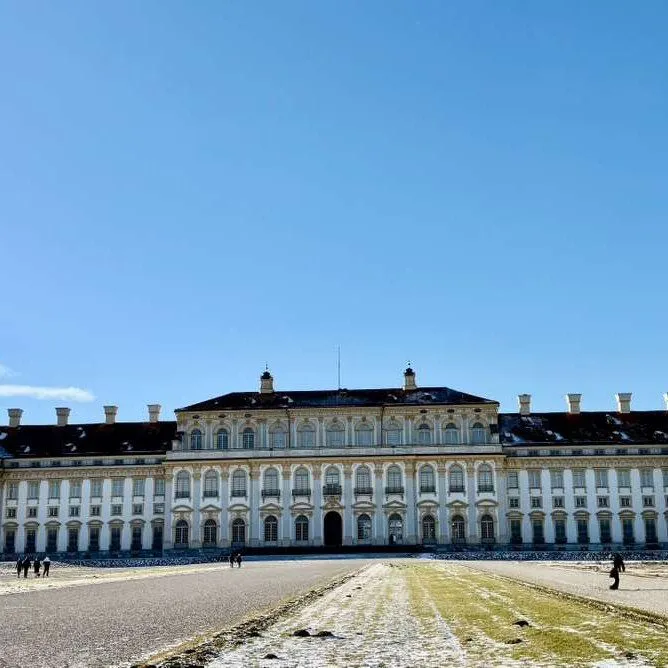 The grand white facade and water canals of the New Palace in Oberschleissheim near Munich