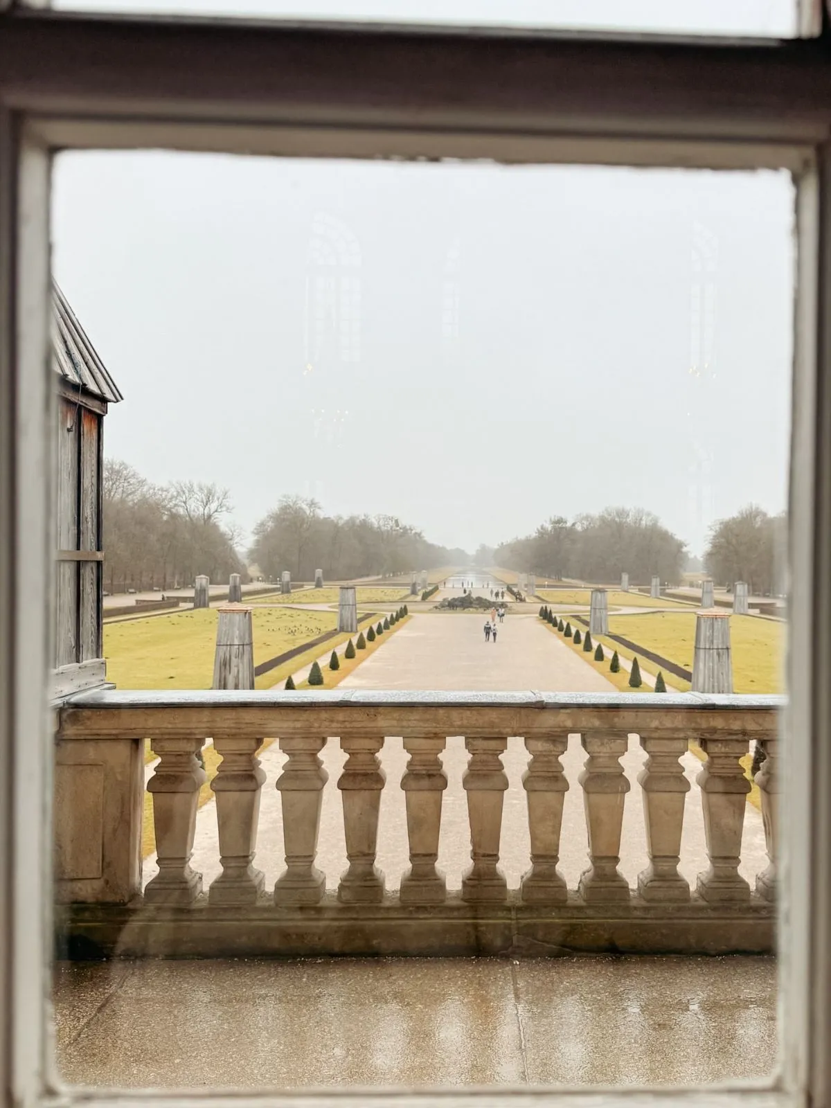 Manicured garden paths with statues and hedges at Schleissheim Palace