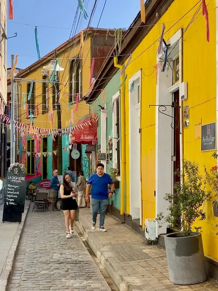 Colorful Pasaje Galvez alleyway in Valparaiso with checkerboard tiles and street art