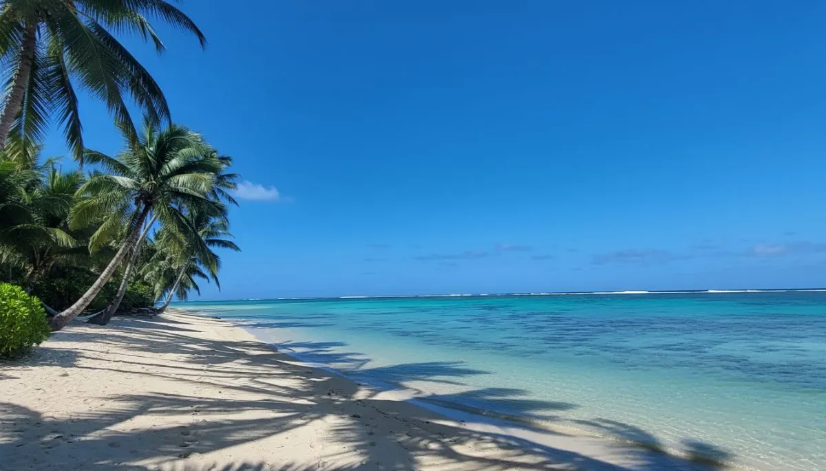 A couple on a scooter overlooking the turquoise lagoon and volcanic mountains of the Cook Islands.