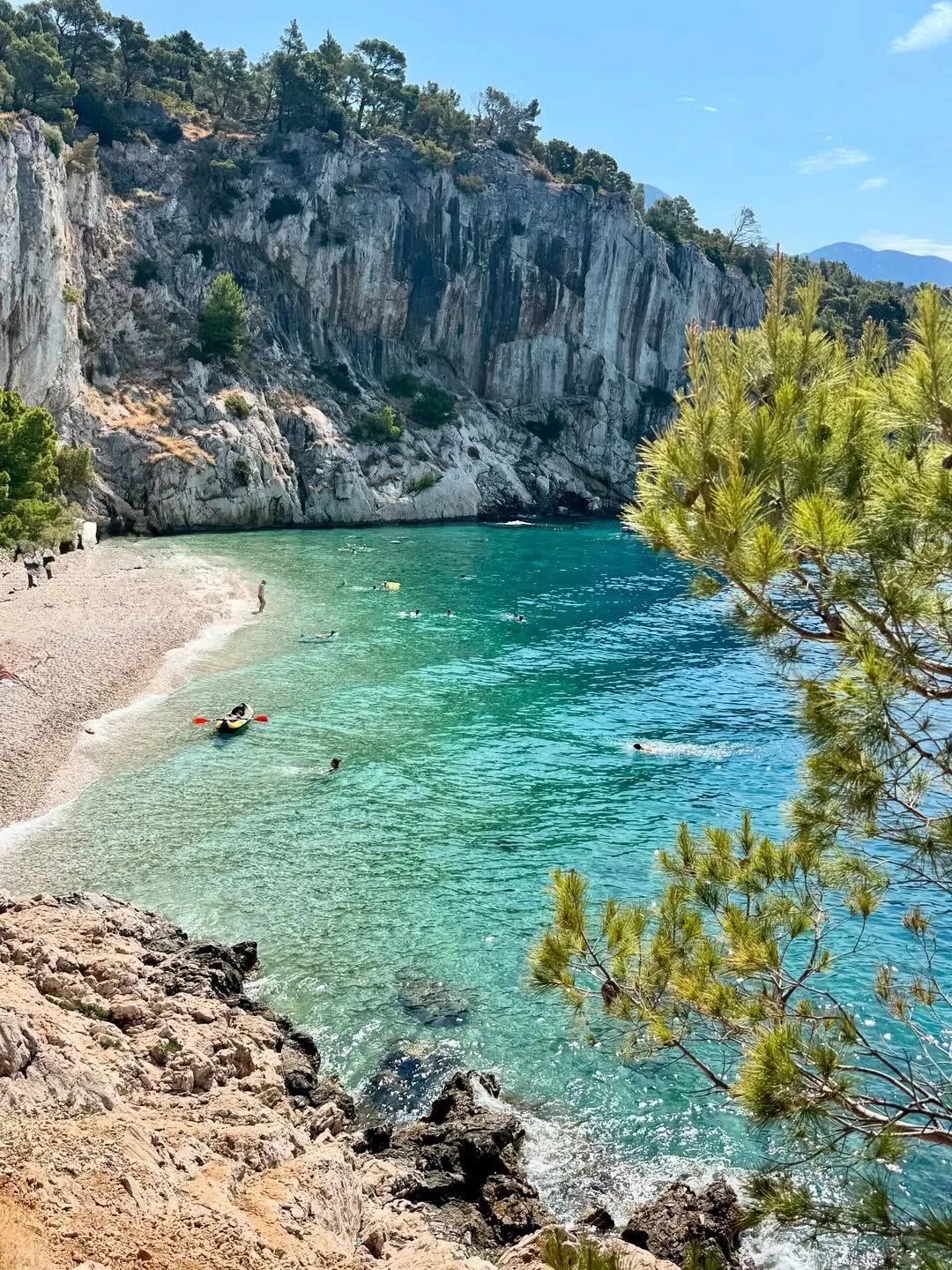 A quiet turquoise bay with limestone cliffs in Croatia
