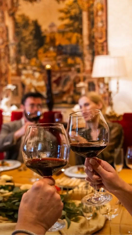 Travelers enjoying wine tasting in a Roman cellar during a food tour