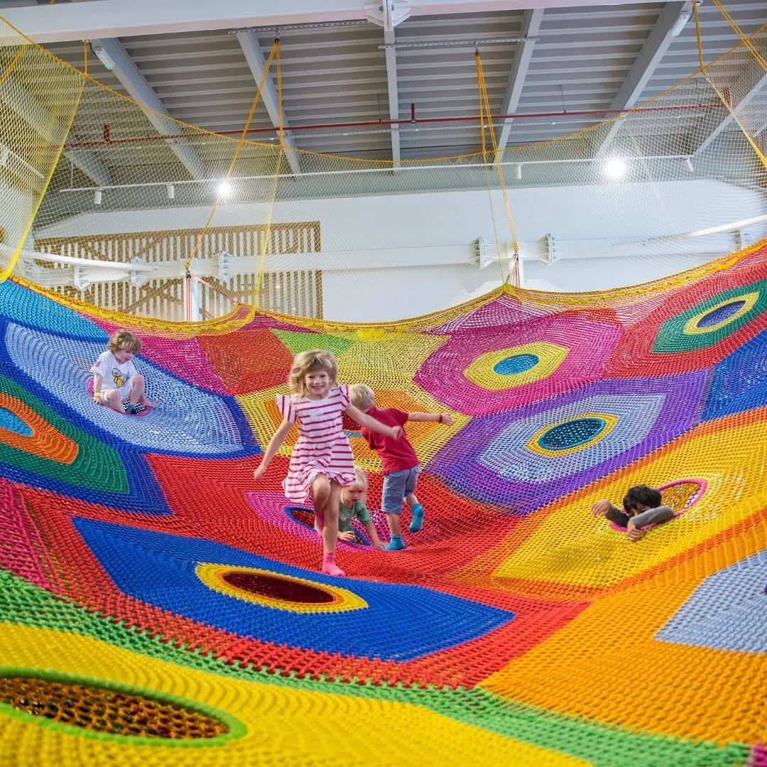Colorful hand-knitted textile climbing net at OliOli Dubai