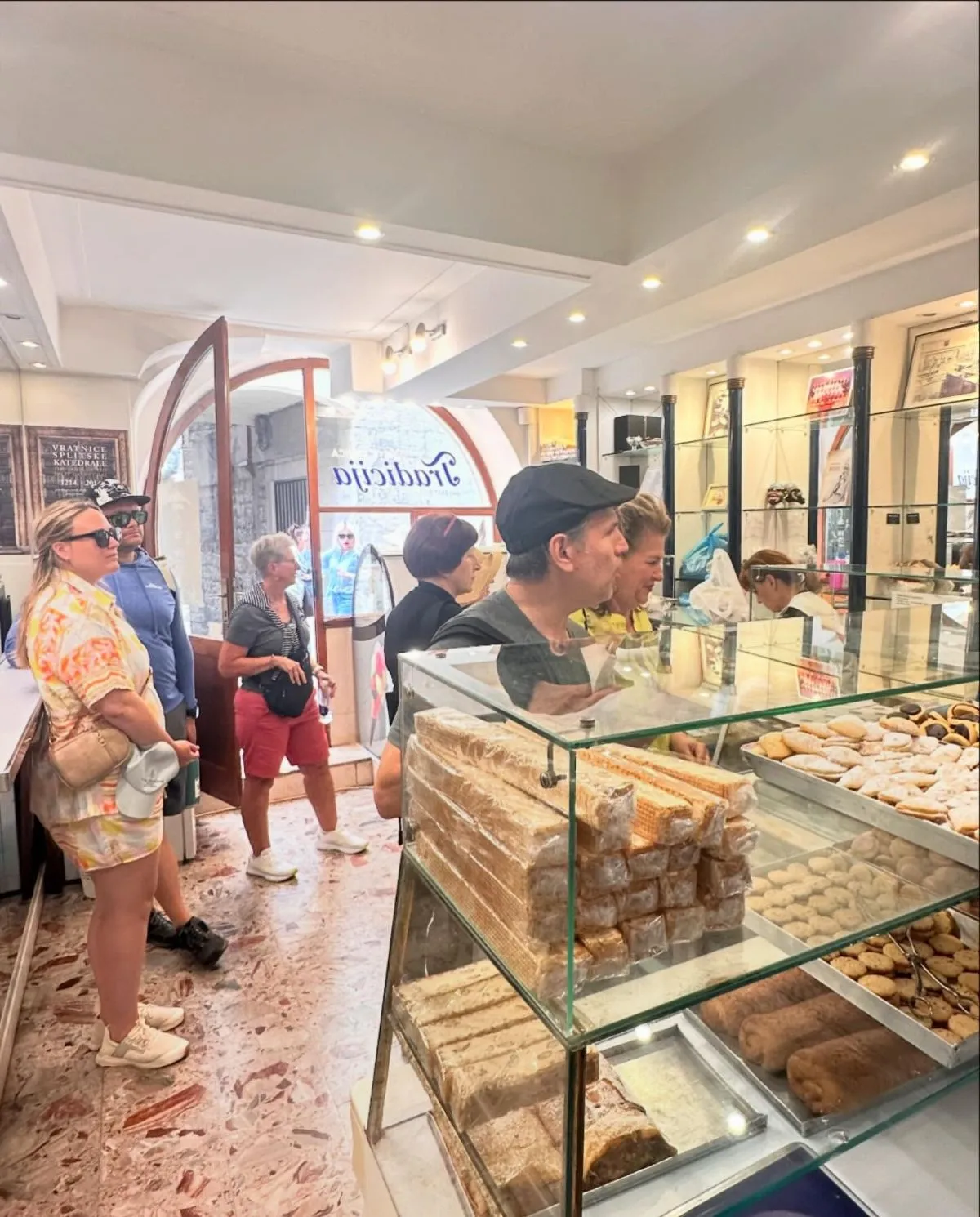 A traditional Croatian bakery window showcasing fresh golden pastries