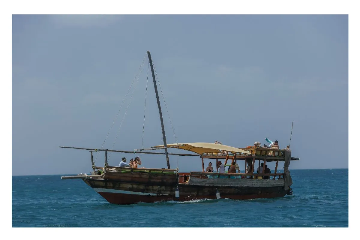 Traditional wooden dhow boat sailing near mangrove forests in Wasini Island Kenya