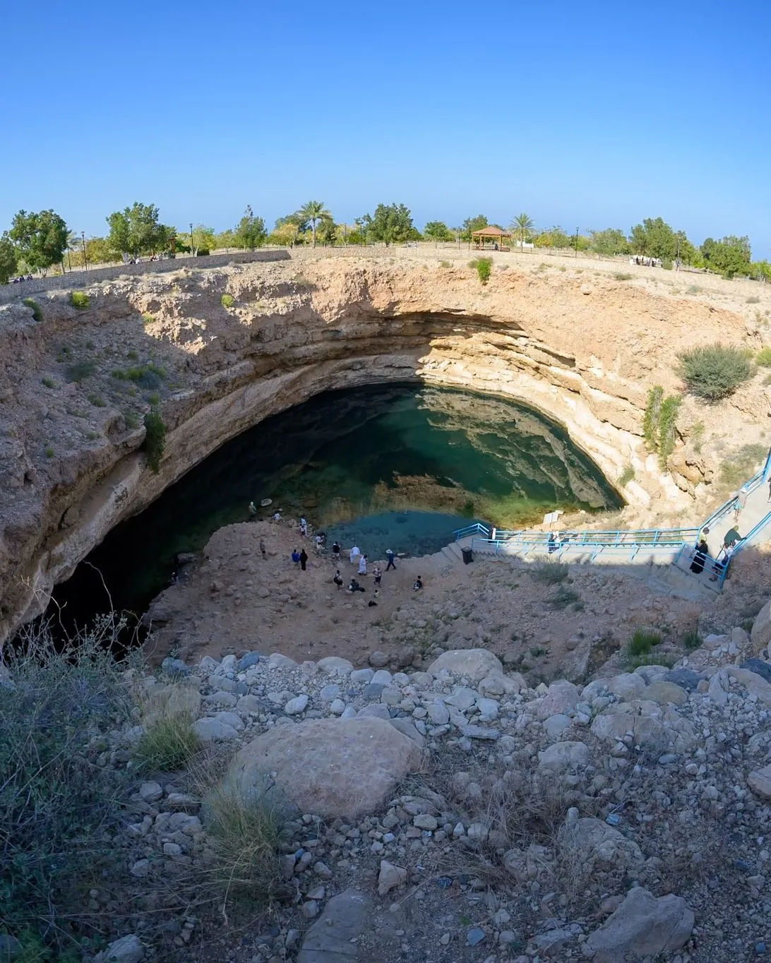 Turquoise water pools in a deep rocky canyon at Wadi Shab Oman