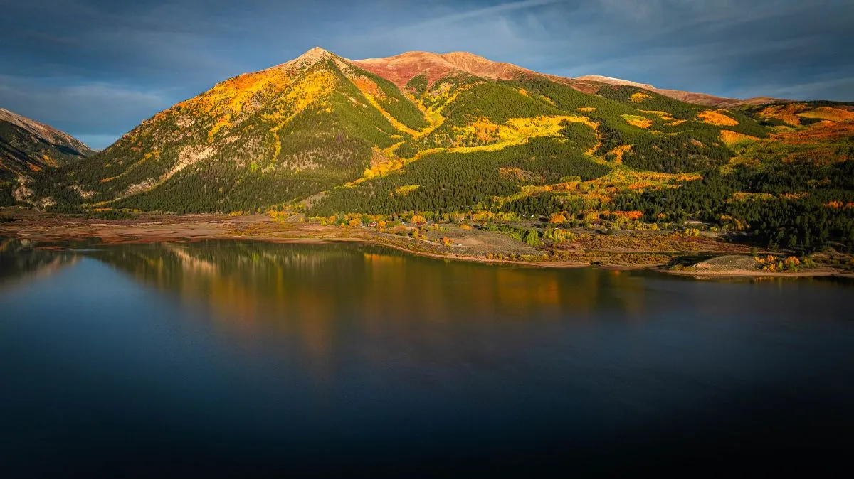 Mount Elbert reflecting in the calm blue waters of Twin Lakes Colorado during sunrise