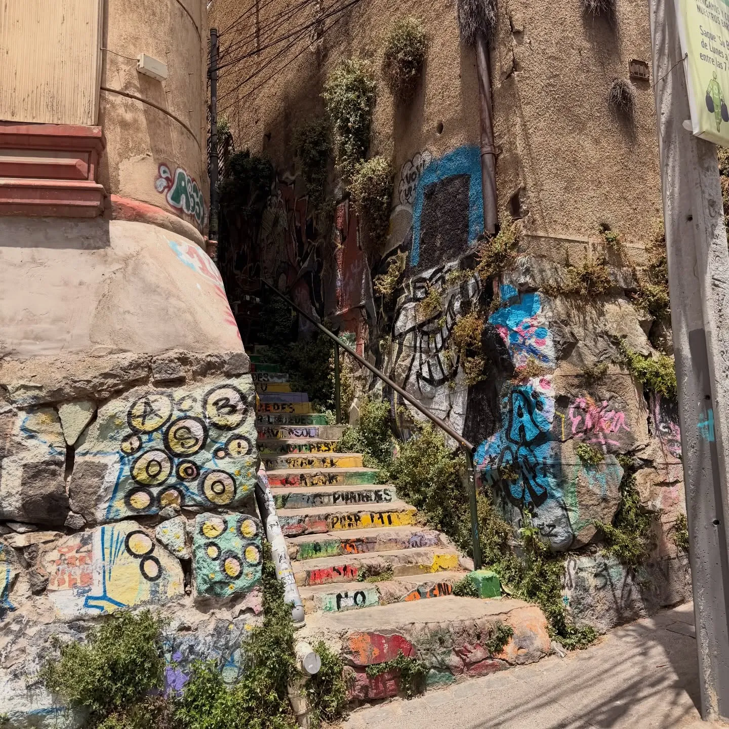 Detailed view of colorful street art murals on concrete walls in Valparaiso
