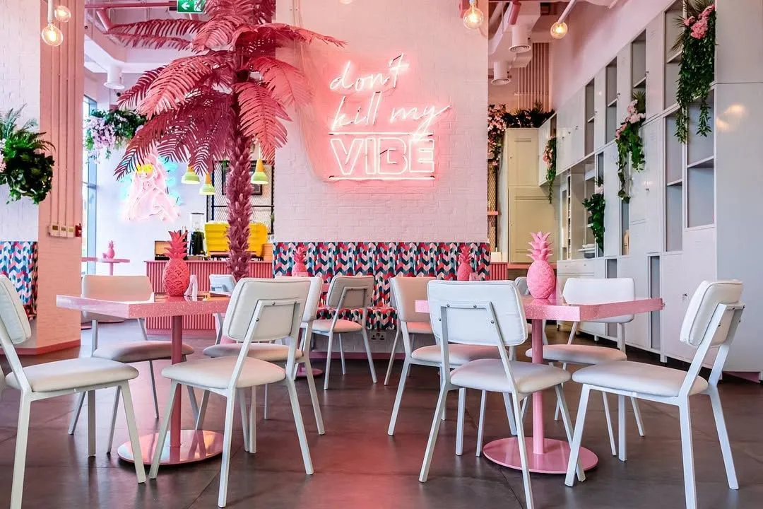 Trendy pink and green tropical interior of Vibe Cafe in City Walk Dubai