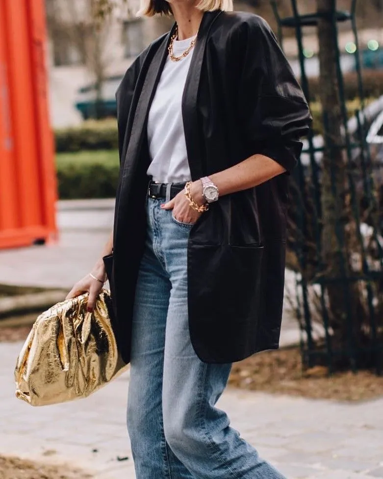 Close up of black blazer over white t-shirt with cafe background