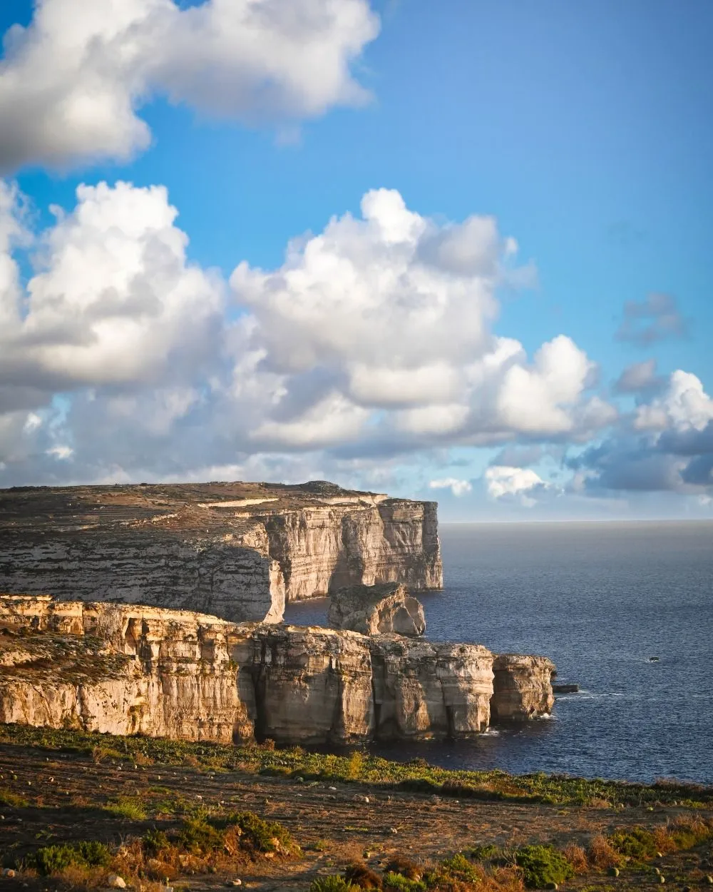 View of Fungus Rock in Dwejra Bay from a hiking trail on Gozo