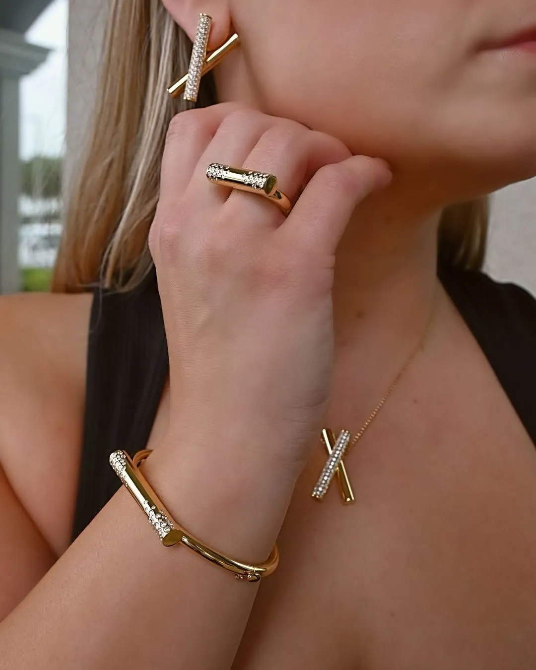 Detail shot of layered gold necklaces and cocktail styling