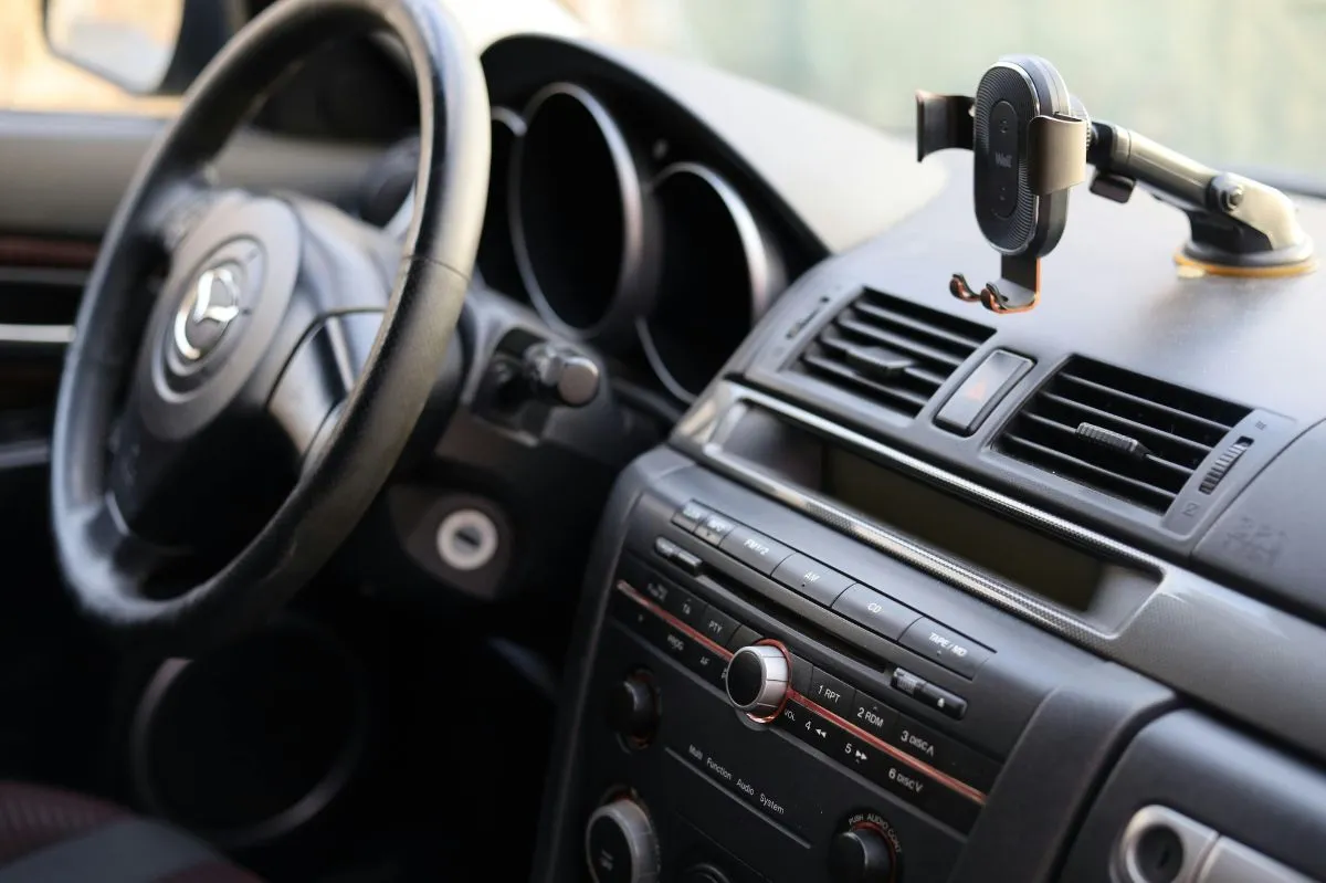 Magnetic phone holder attached to car air vent for hands-free driving