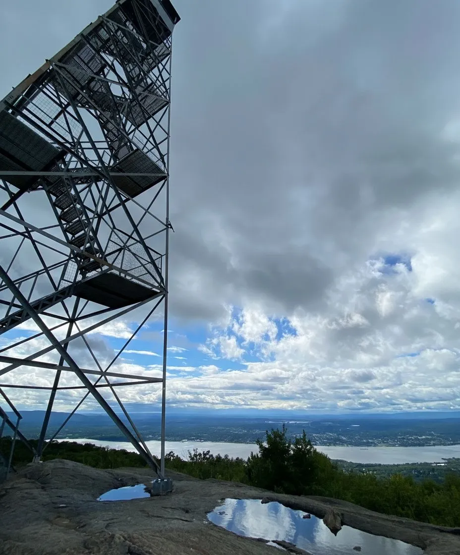 Steel fire tower structure on the summit of Mount Beacon against a blue sky