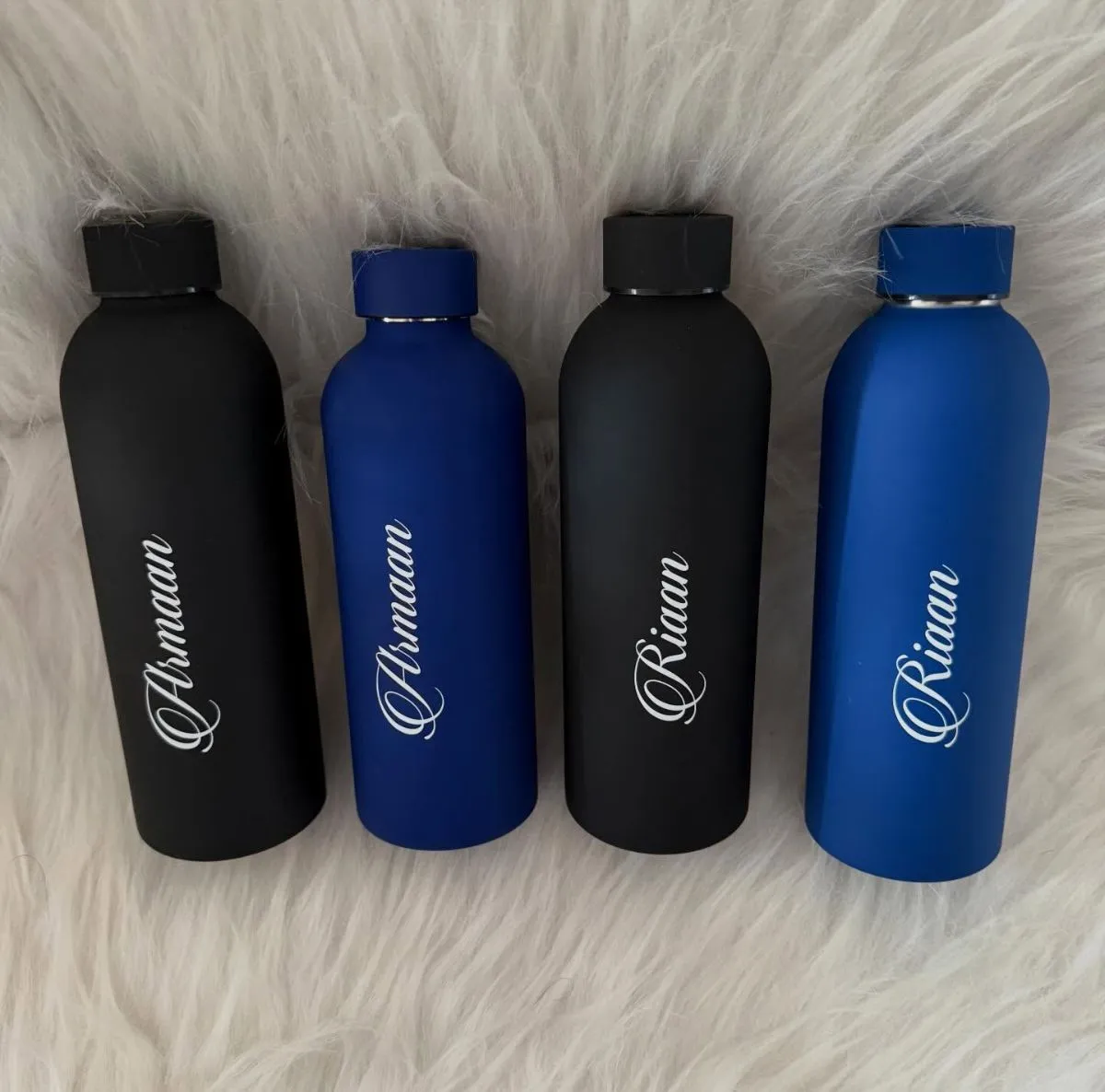 Stainless steel water bottle in car cup holder during summer road trip