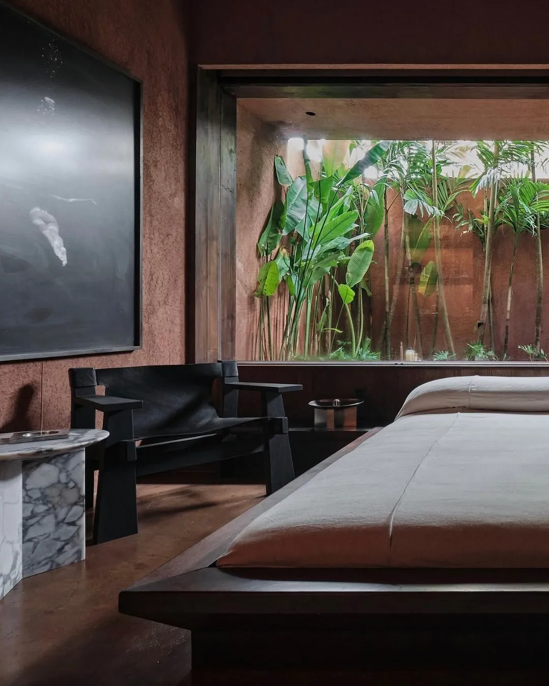 Interior of a minimalist luxury suite at Further Hotel with large windows and natural textures.