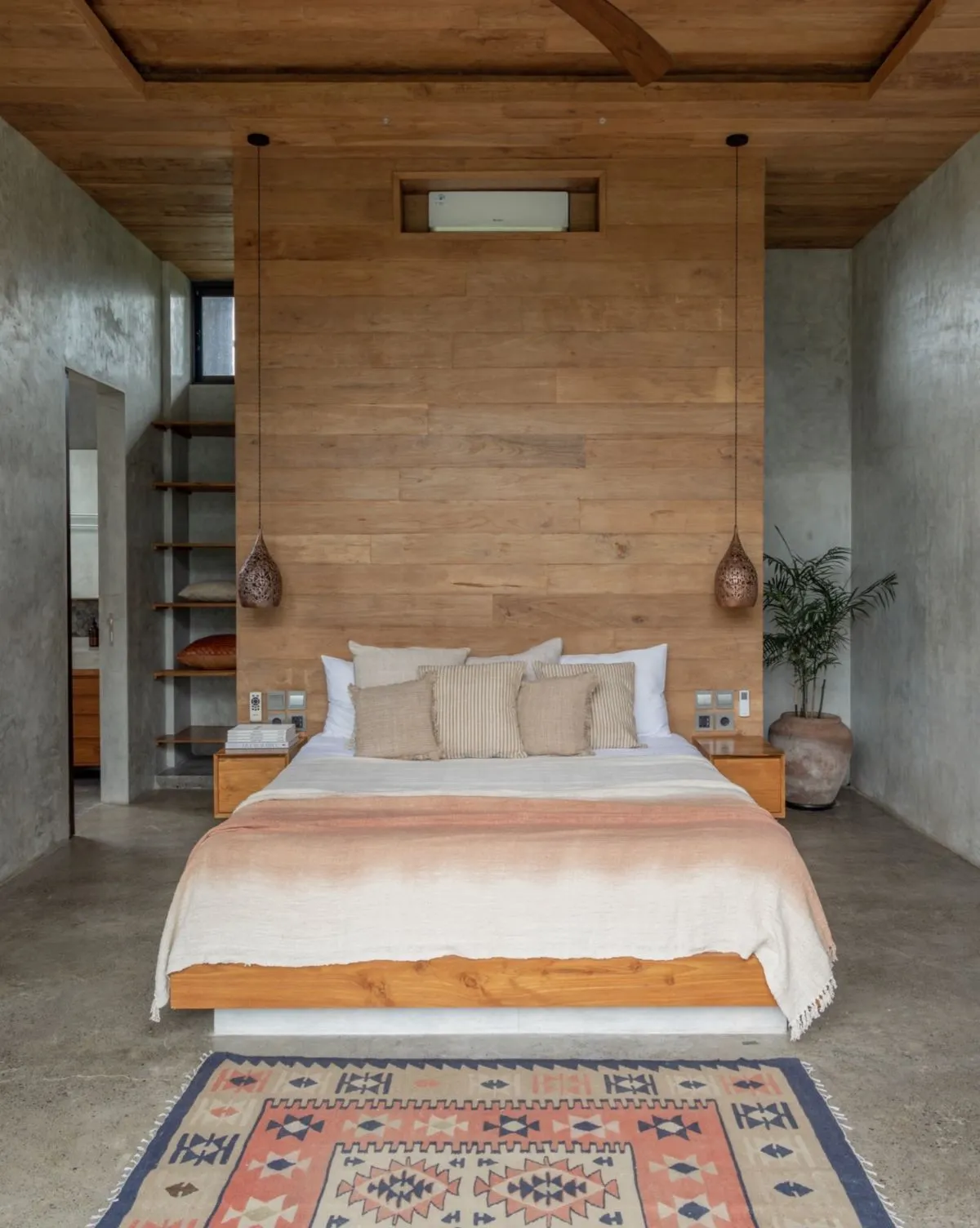 Boutique villa bedroom with natural wood and floor-to-ceiling windows
