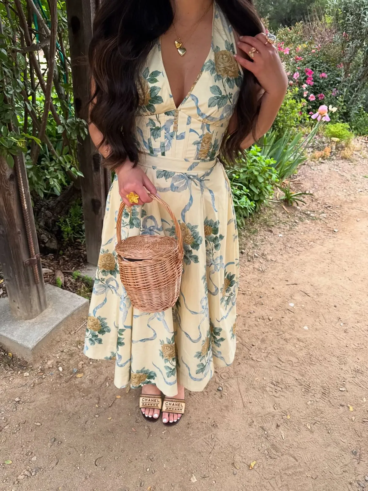 Woman wearing floral wrap dress and wedge espadrilles on cobblestone street in Paris