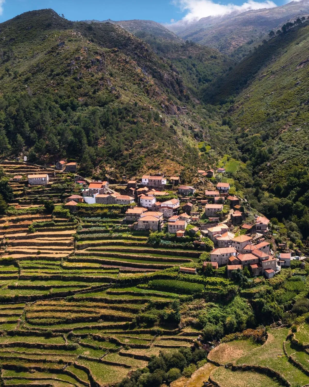 Scenic view of the lush green terraced hillsides and traditional stone village of Sistelo in Northern Portugal.