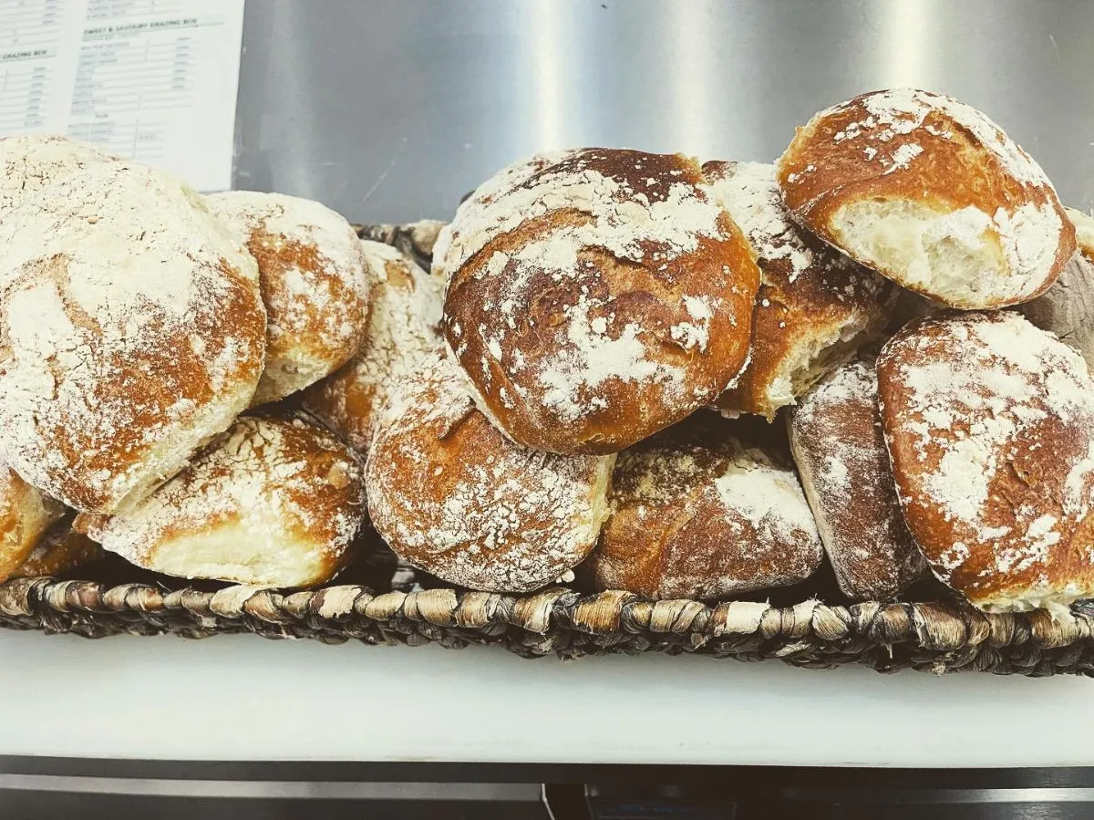 Freshly baked ring-shaped Maltese Ftira bread on a wooden table