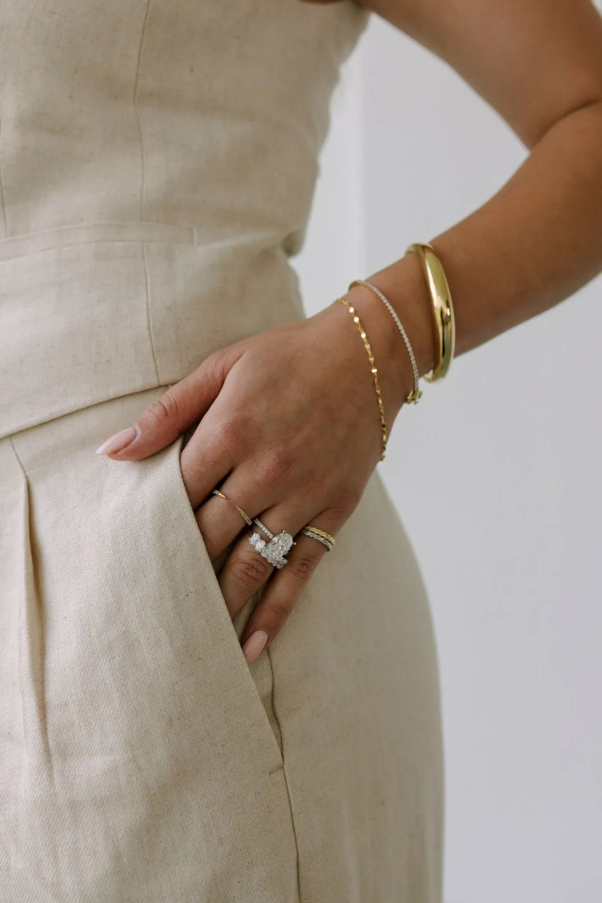 Flat lay of gold jewelry on a marble table with coffee in Paris