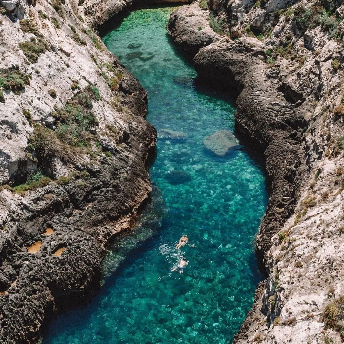 Narrow turquoise water inlet at Wied il-Ghasri gorge in Gozo