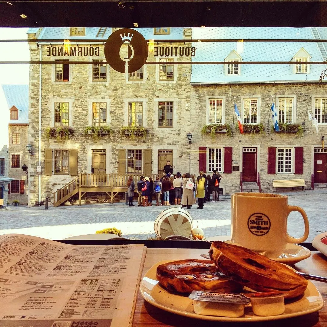 Fresh croissant and coffee on a cafe table in Quebec City