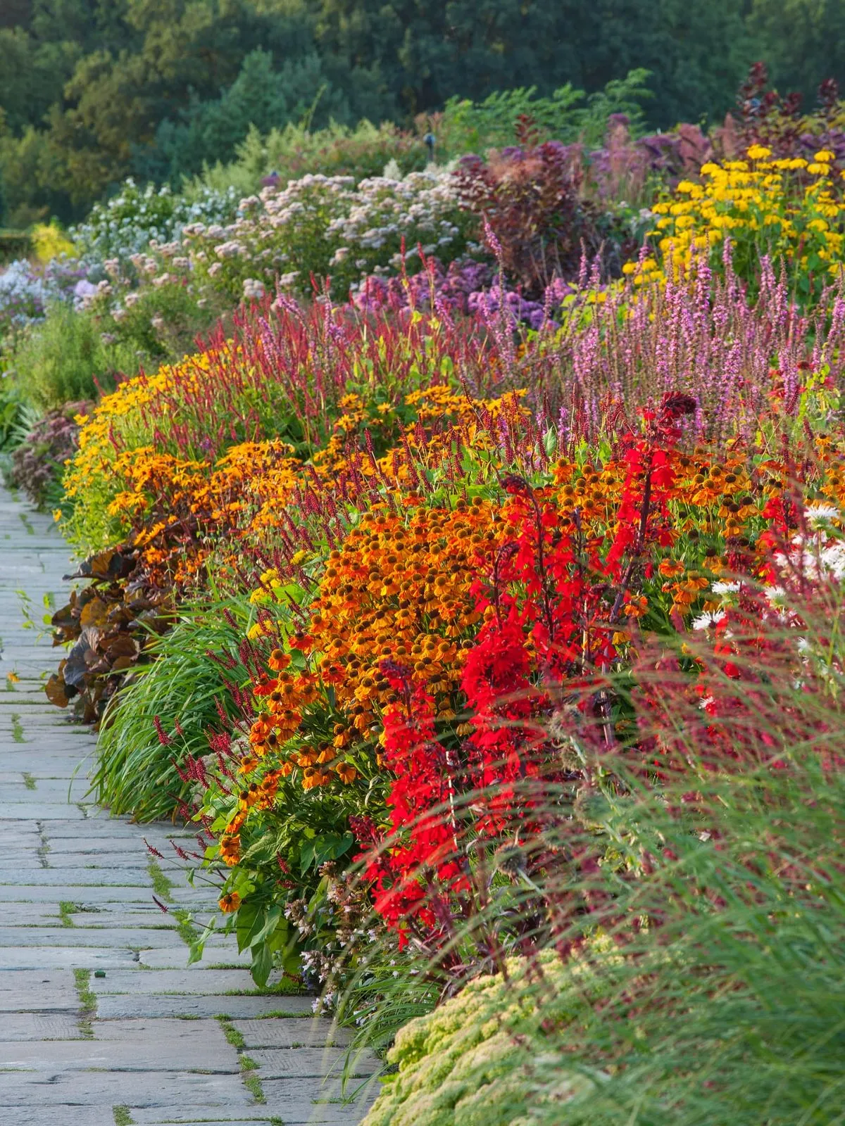 Vibrant flowers blooming in front of ancient medieval castle walls