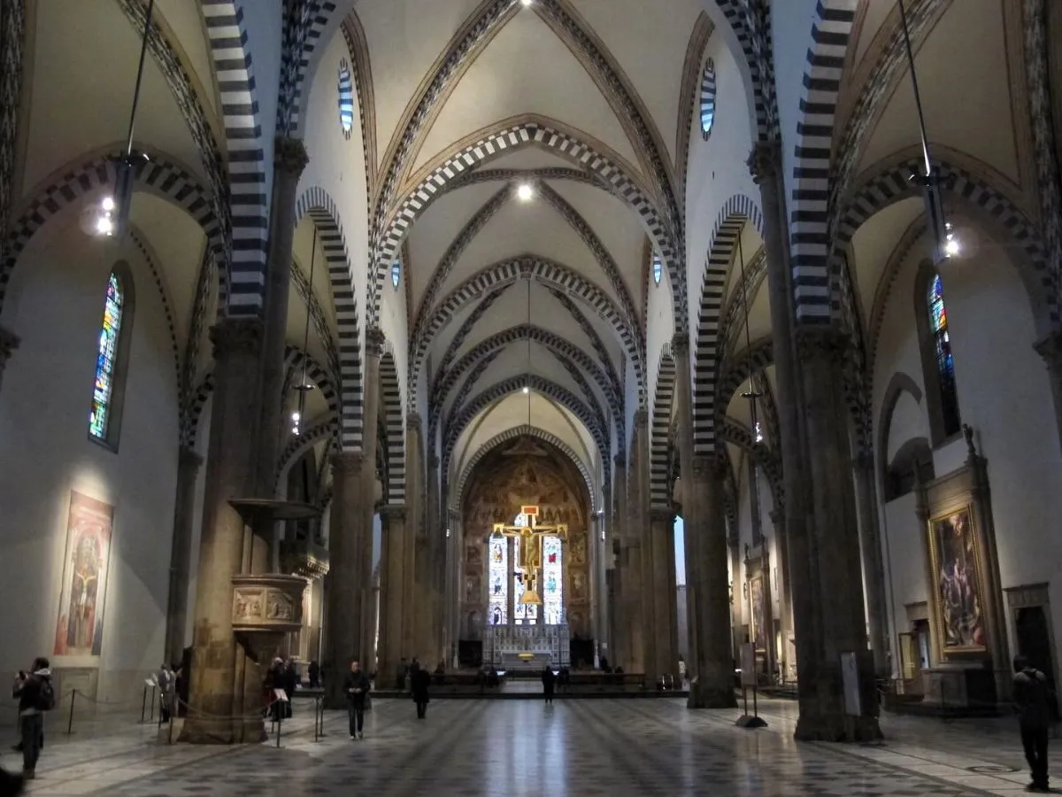 The spacious interior of the Santa Maria del Fiore cathedral in Florence with vaulted ceilings and mosaic floors