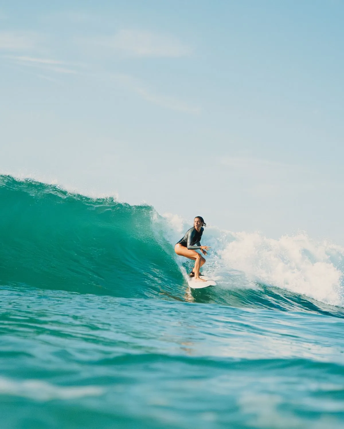 Surfer riding a wave at La Zurriola beach during a Basque Country honeymoon