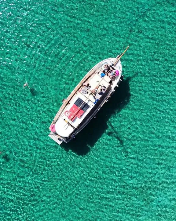 Wooden water taxi sailing on the Aegean Sea in Paros
