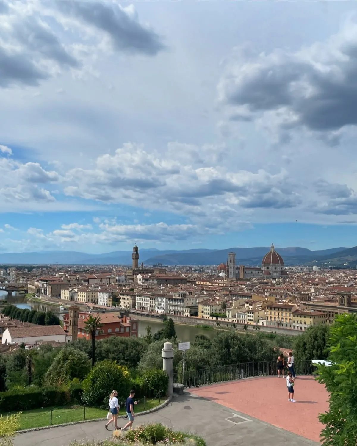 The scenic walking path known as Rampe del Poggi, a stone staircase surrounded by trees leading to Piazzale Michelangelo.