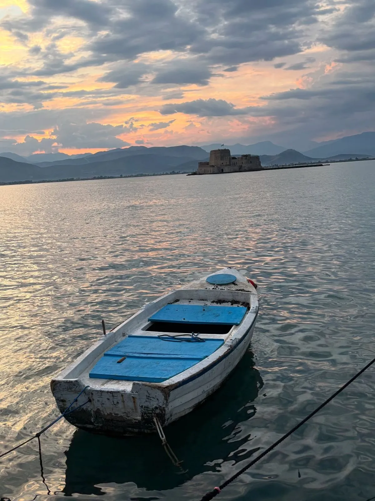 Sunhat resting on the wooden deck of a Greek boat