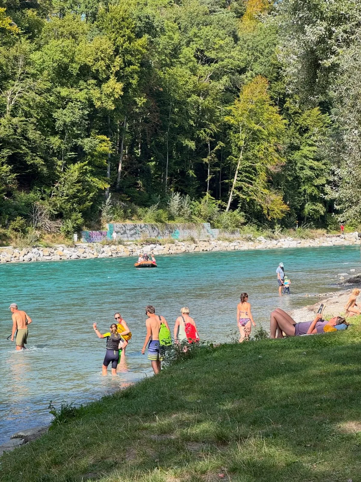 Sunny riverbank at Eichholz Camping in Bern with turquoise Aare river
