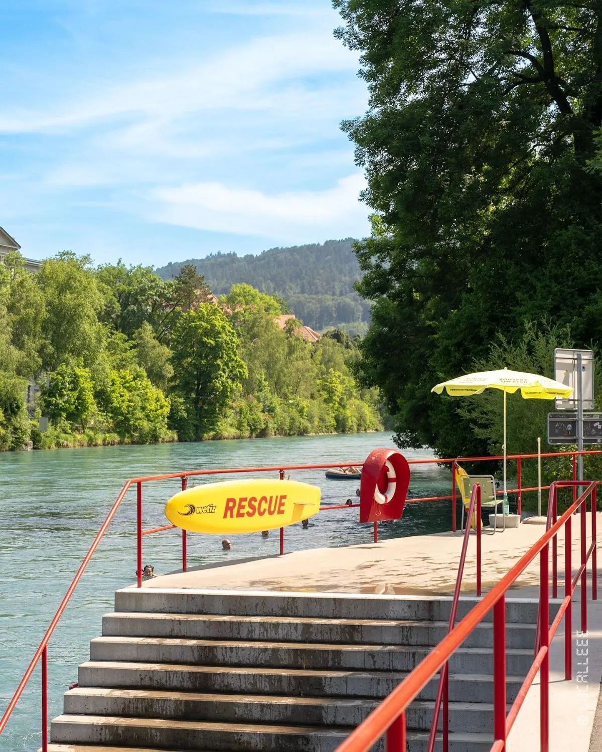 Bright red grab bars at the Marzili exit along the Aare River in Bern