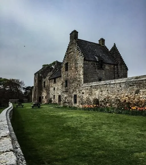 Ancient stone walls and terraced gardens at Aberdour Castle in Scotland.