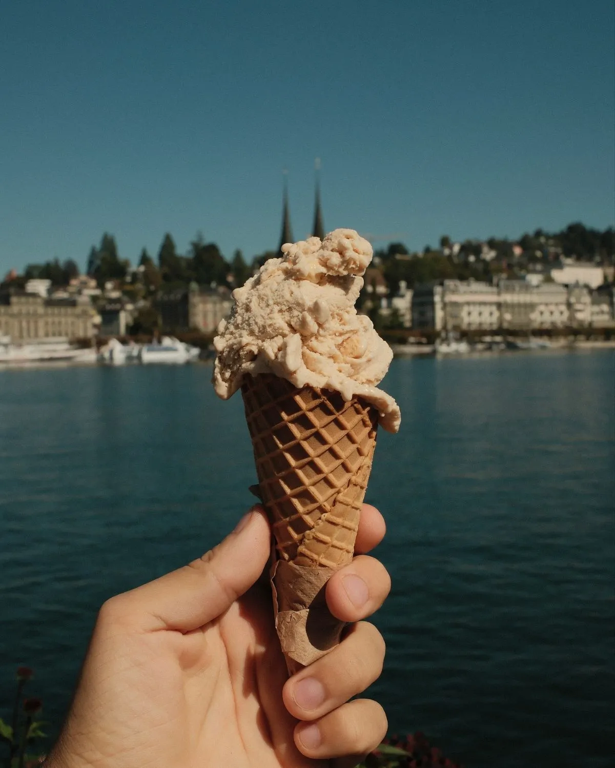 Holding a cone of fresh gelato near the Aare River in Bern