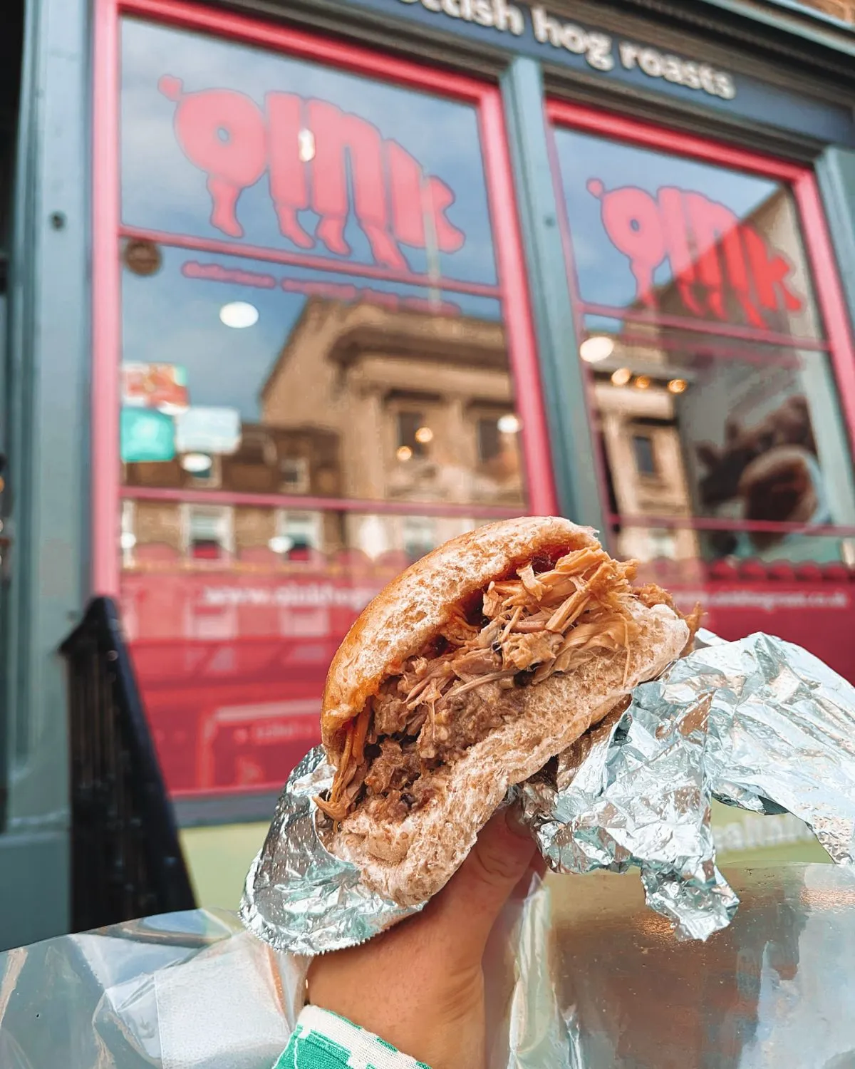 A succulent hog roast roll with crackling and apple sauce from Oink, a famous budget-friendly eatery in Edinburgh's Old Town.