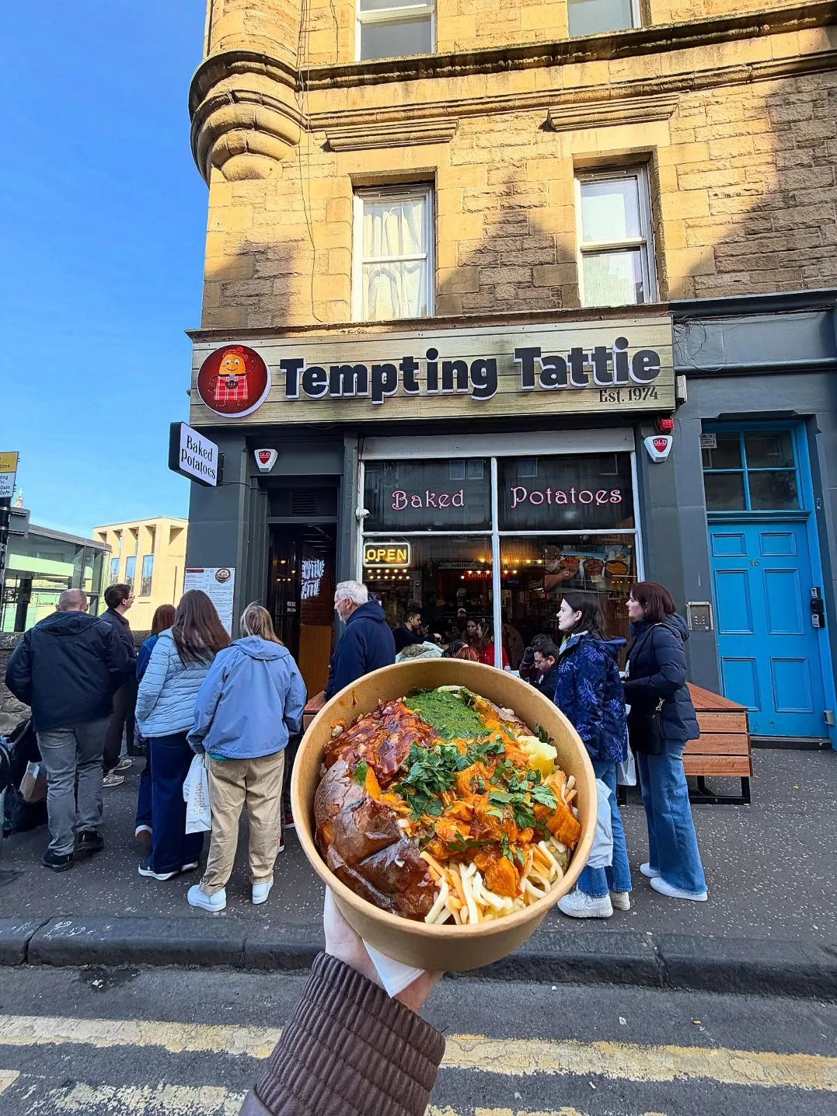 Cozy exterior of a traditional potato shop on Cockburn Street in Edinburgh